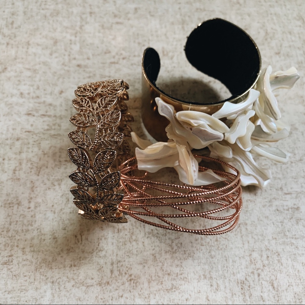 A bundle of 3 gold / rose gold bracelets / cuffs